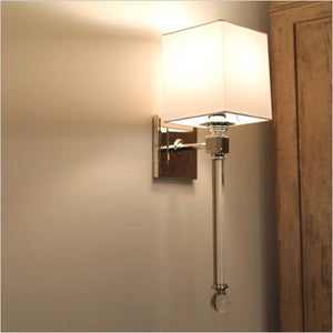 Crystal and polished silver wall sconce with white shade