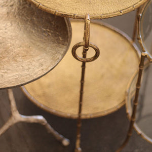 Round accent table in hammered iron with gold leaf finish